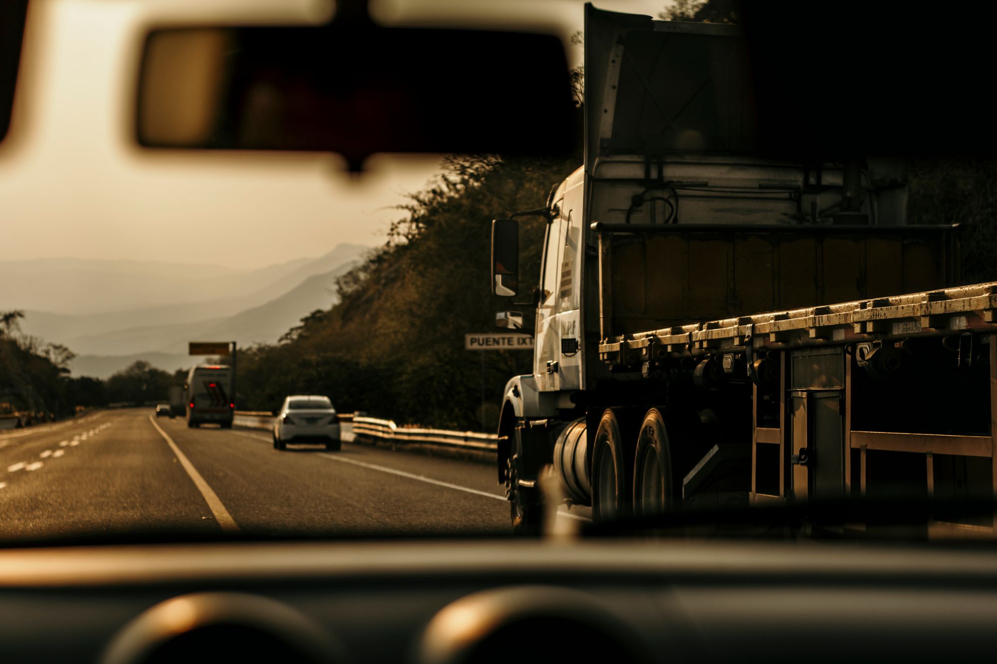 A semi truck on the highway at golden hour